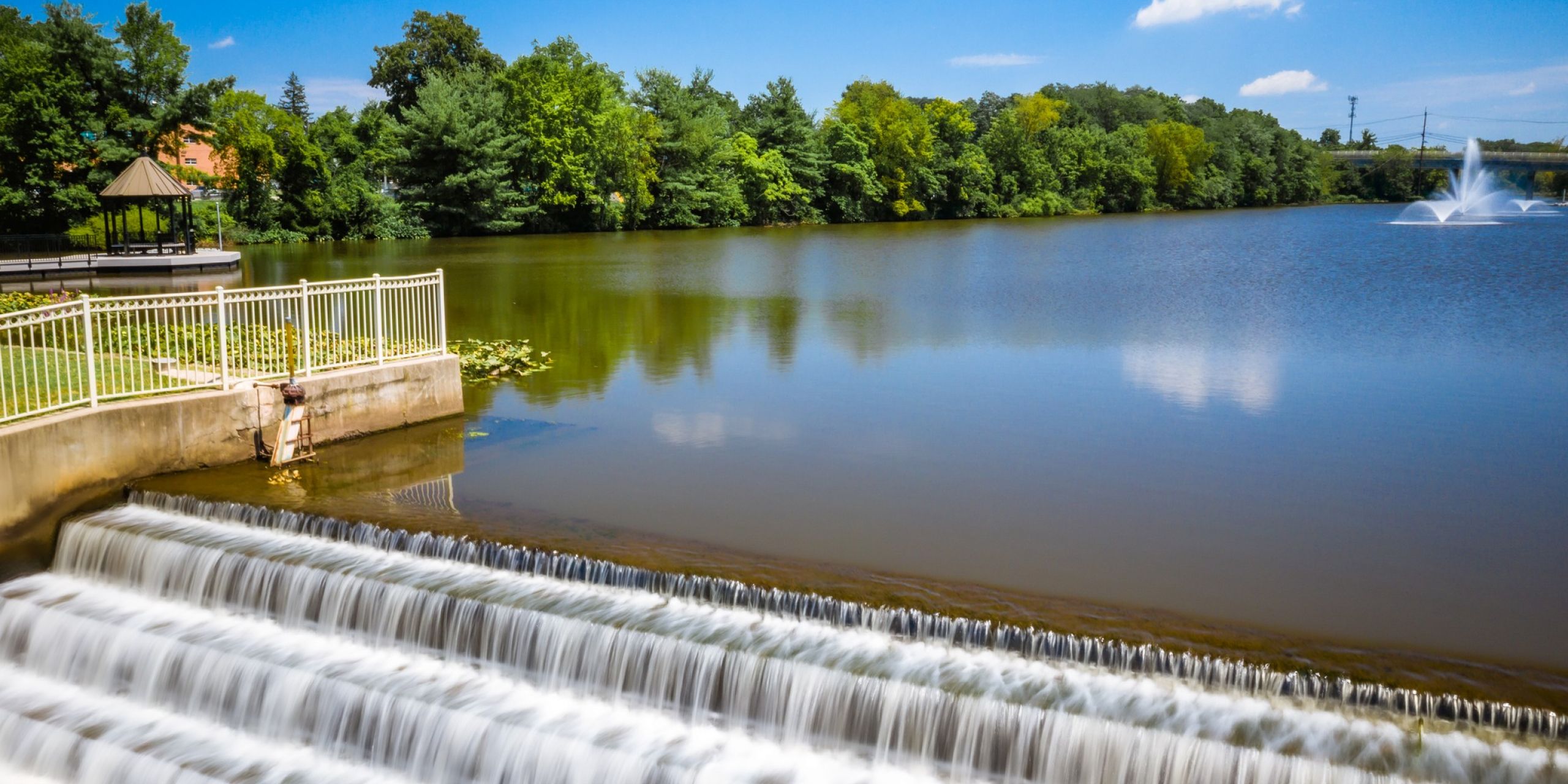 Nelson Lake Park view of Nelson Lake, water fountains and waterfall, with pretty gazebo and summer foliage in Piscataway, NJ near River Road Estates luxury homes